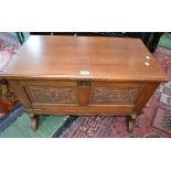 An oak side cabinet, rectangular top, over sloping fall front,