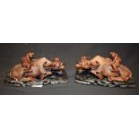 A pair of Chinese hardwood carvings, of boys astride water buffaloes,