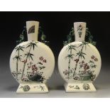 A pair of Aesthetic Movement pottery moon flasks, printed in green with bamboo, Geisha,