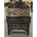 An early 20th century Chinese bureau profusely carved throughout