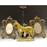 A pair of late 19th century easel mirrors, the frames cast with scrolling foliage,