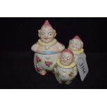 A novetly pottery cruet set, modeled as clowns, 9.