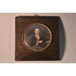 French School (19th century), a portrait miniature, of a gentleman at his papers,