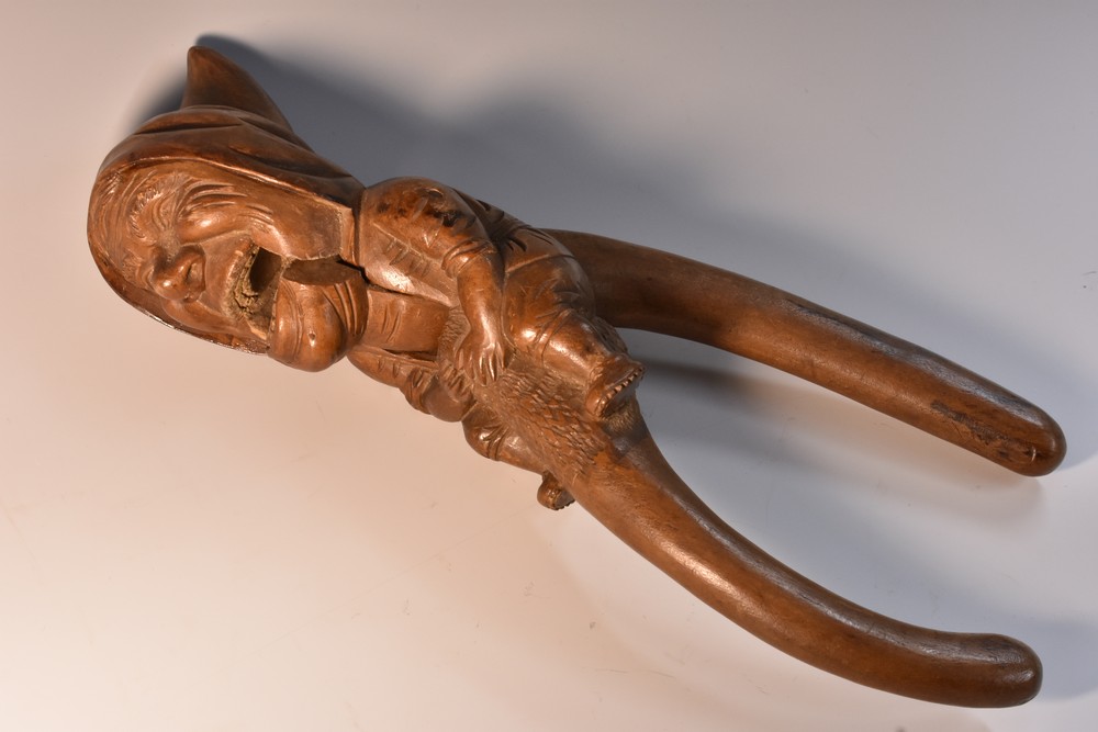 A Black Forest novelty lever-action nut cracker, carved as a gnome, full-length, 27.