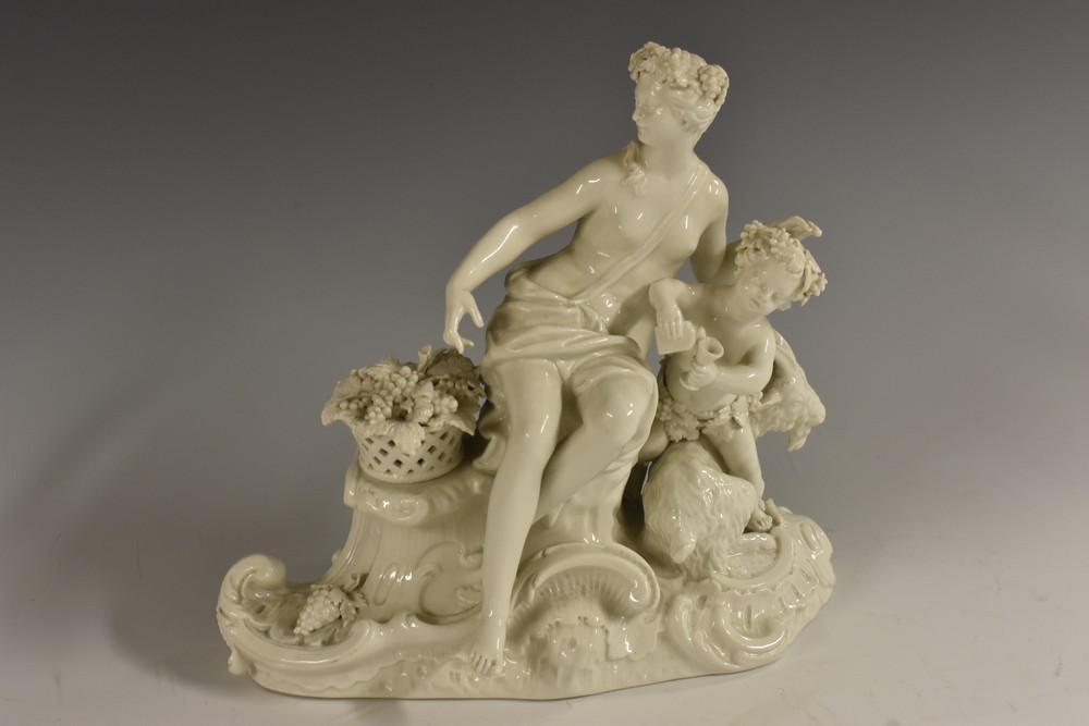 A Berlin porcelain Classical figure group, of a scantily draped maiden,