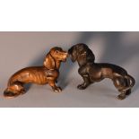 A Black Forest miniature model, carved as a dachshund, 8cm long, early 20th century; another,