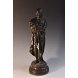 A 19th century bronzed spelter library figure, of Sir Walter Scott, he stands holding a pen,