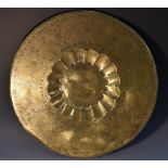 A 19th century Indian brass charger, engraved with warriors and figures of the court,