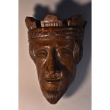 A 19th century oak boss, carved in the Medieval taste as the head of a king, 17.