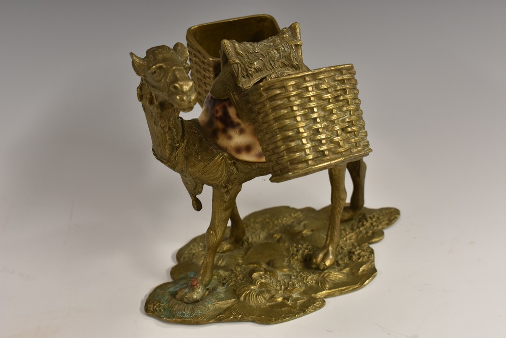 An unusual 19th century gilt bronze and cowrie shell novelty table vesta, cast as a saddled camel,