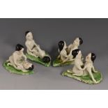 A set of four Japanese novelty erotic porcelain figural groups, each couple modelled on a leaf,