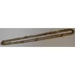 A Victorian/Edwardian 9ct gold fancy link muff chain, 136cm long,