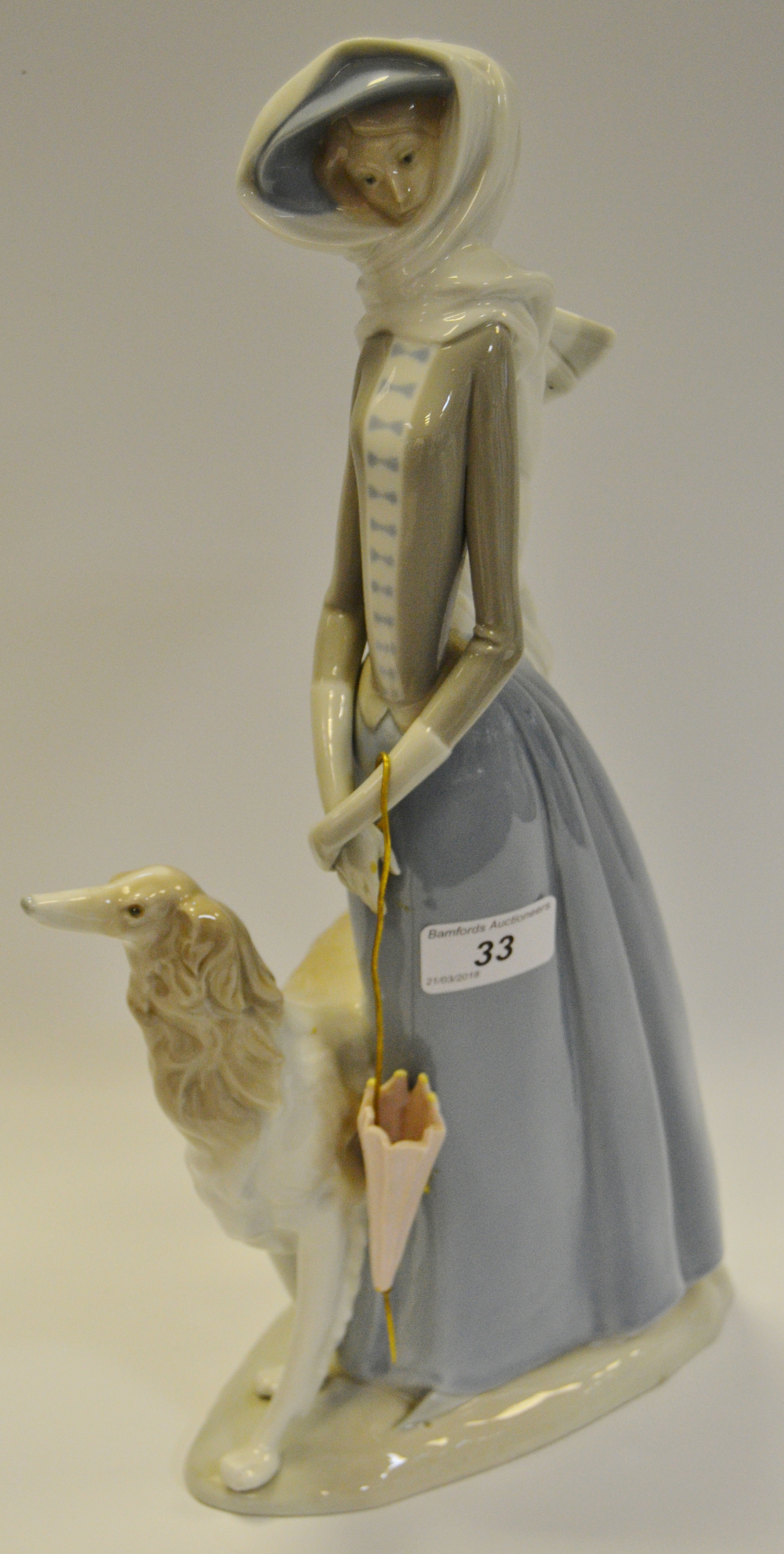 A Lladro figure of a Lady with a Borzoi Dog and parasol