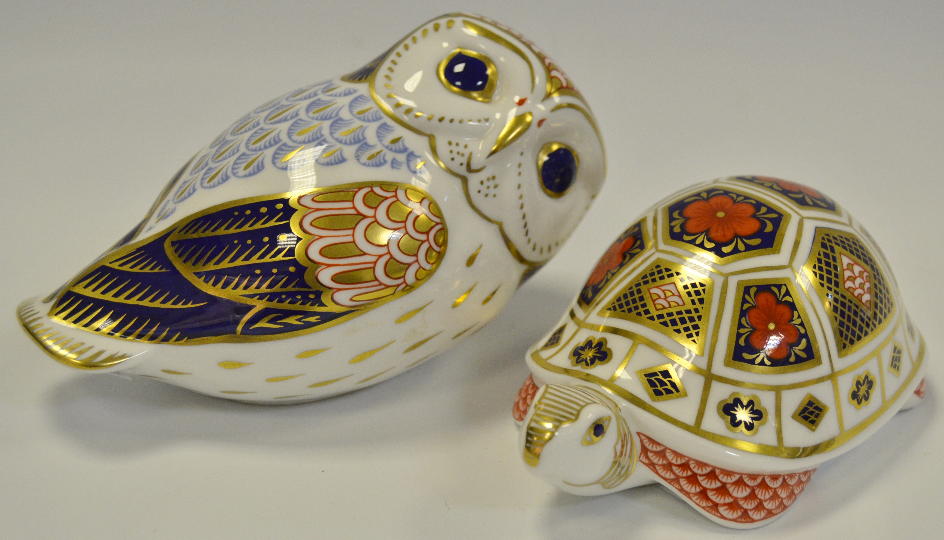 A Royal Crown Derby paperweight Owl, gold stopper; another Tortoise,