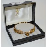 A 9ct gold gatelink bracelet, heart shaped locket (10.