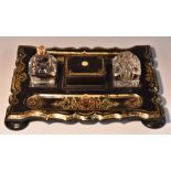 A Victorian papier mache shaped rectangular inkstand, glass wells divided by a wafer box,