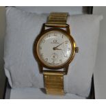 A gentleman's Garrard 9ct gold wristwatch, circular champagne dial, Arabic numerals,