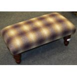 A tartan wool footstool, in tones of purple,