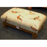 A contemporary footstool upholstered in fabric depicting Pheasants