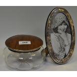 A large silver mounted dressing table jar; an oval silver photograph frame ,