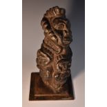 Tribal Art - an African stone carving, depicting a stylised face above four figures,