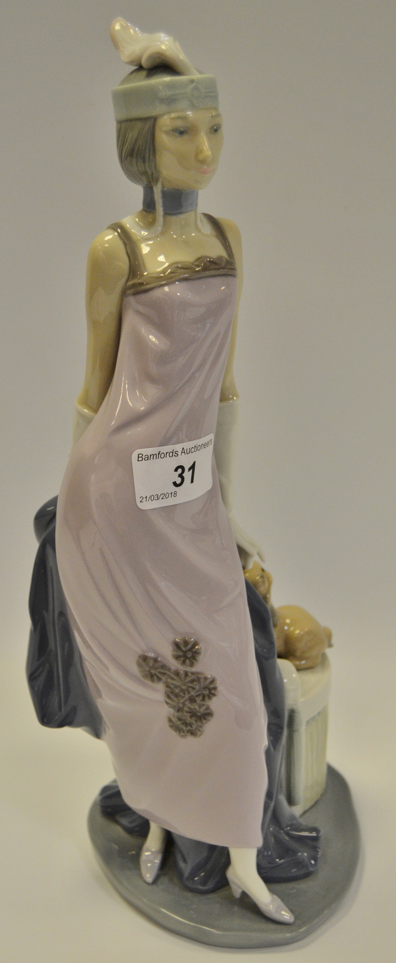 A Lladro figure of a Lady in early 20th century attire,