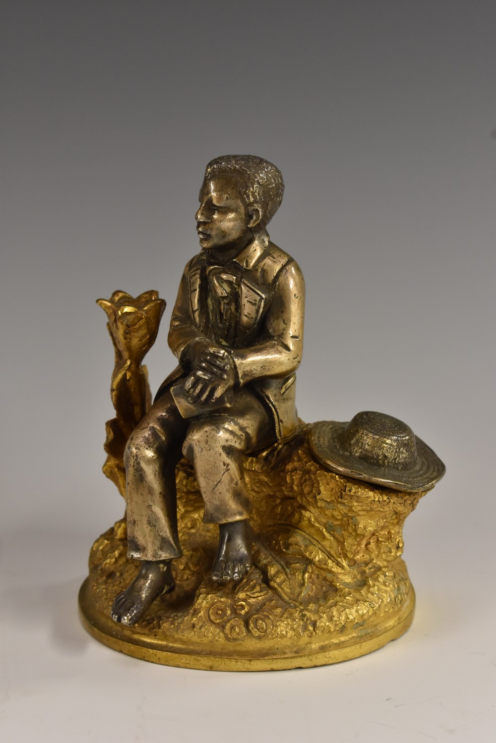 A 19th century gilt and silvered bronze novelty inkwell, cast as a well dressed young man,