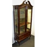 An early 20th century mahogany display cabinet,crushed velvet lined interior , Swan neck pediment,