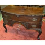 A reproduction bowfront sideboard, long drawer over arched recess flanked by drawers,