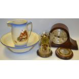 A Staffordshire wash bowl and jug; an Anniversary clock; an oak Napoleon hat mantel clock;