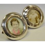 A pair of circular silver photograph frames, wooden back, 9cm diam.