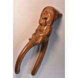 A Black Forest novelty lever-action nut cracker, carved as a gnome, full-length, 27.