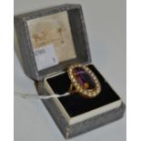 An 18ct gold lady's dress ring set with purple stones surrounded by fresh water pearls, 12.