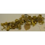 A 9ct gold charm bracelet, with approx 38 various charms, including an Art Nouveau pendant, fob,