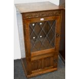 A mid 20th century 'Jacobean Revival' oak cabinet, astral glazed door,