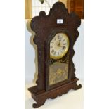 An American Gingerbread clock by Waterbury Clock Company, Roman numerals,