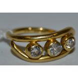 An 18ct gold contemporary diamond trilogy ring set with three diamonds with total approx carat