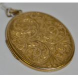 A 9ct gold oval locket, the front engraved and chased with foliate scrolls, 5cm long,