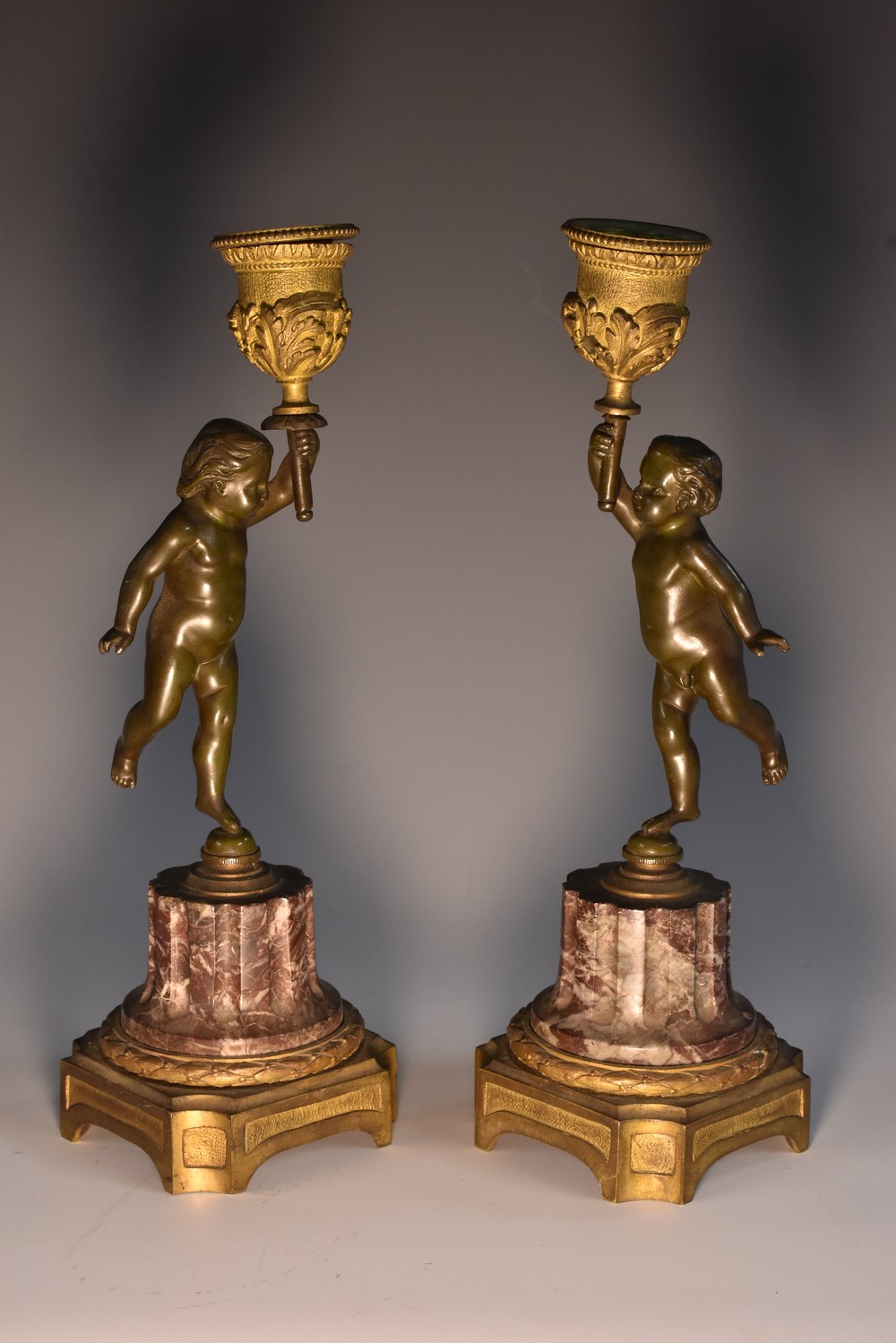 A pair of 19th century gilt bronze, ormolu and veined marble mantel candlesticks,