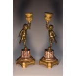 A pair of 19th century gilt bronze, ormolu and veined marble mantel candlesticks,