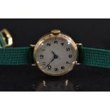 Omega - a lady's vintage 1920s 9ct gold cased wristwatch, textured silvered dial, Arabic numerals,