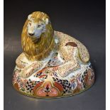 A Royal Crown Derby paperweight, Lion, transfer printed with a mouse nestling within his paws,