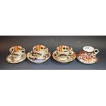 A pair 19th century of Spode Imari palette coffee cups, a Spode saucer, a similar Derby saucer,