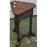An oak occasional table, triangular top, canted corners, acanthus carved border, shaped frieze,