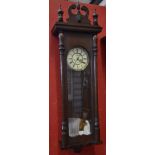 A large oak Vienna wall clock, lion mask pediment, enamelled dial, Roman numerals,