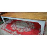 A large pine table, plank top, painted pine base,