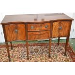 A mahogany serpentine sideboard, two drawers flanked by cupboards, loop handles,