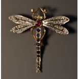 A diamond, emerald, sapphire and ruby dragonfly brooch, shaped arching sapphire tail,