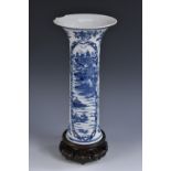 An 18th century Chinese sleeve vase, painted in underglaze blue with monumental landscapes,