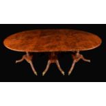 A 19th century burr yew triple-pedestal dining table, rounded rectangular top, turned pillars,